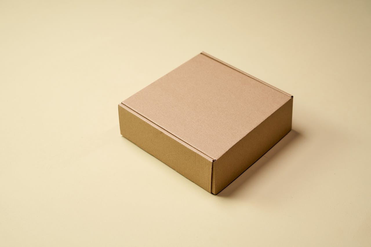 testimonials-img Simple cardboard box displayed on a neutral surface, ideal for product packaging visuals.